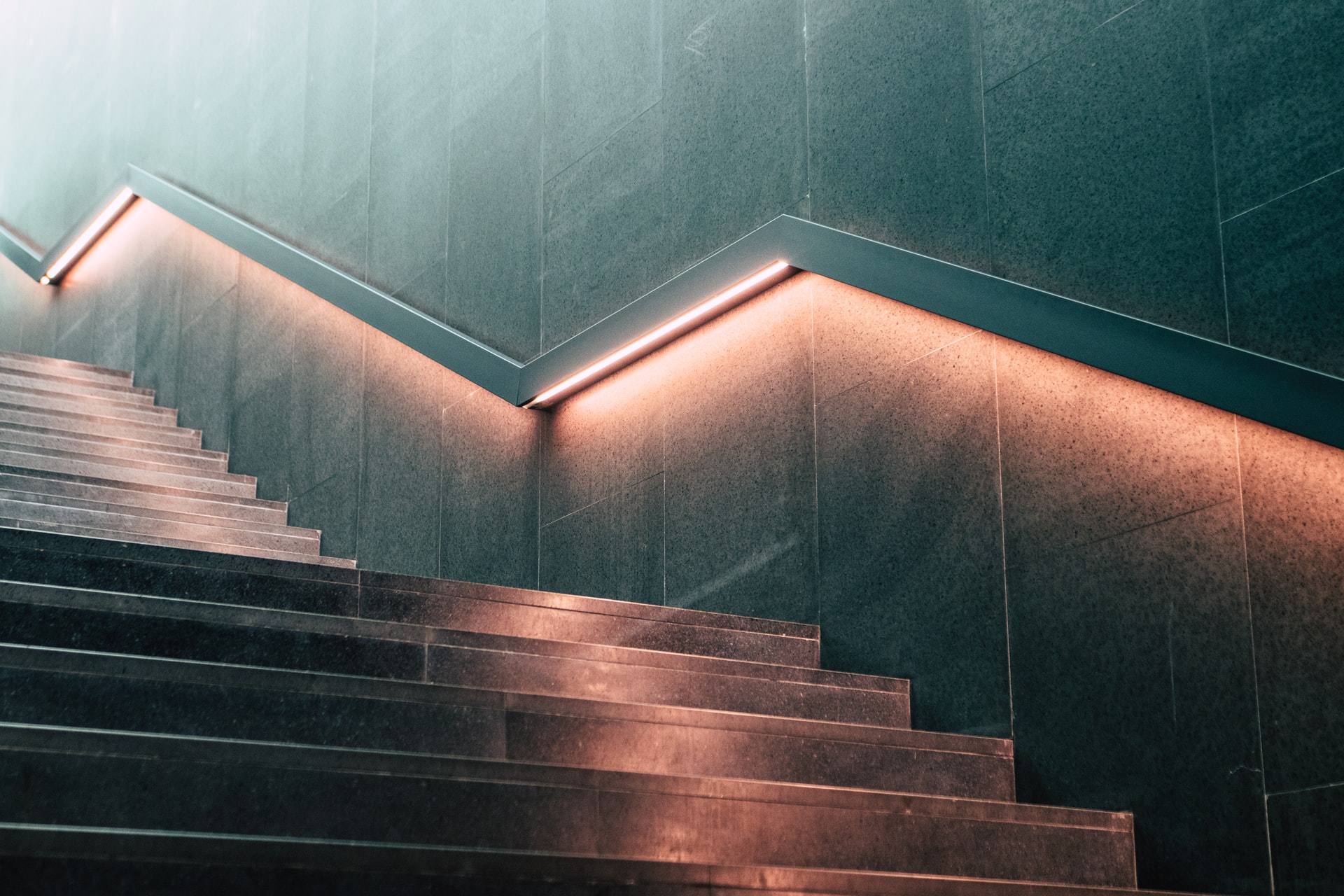 staircase with lighted railing