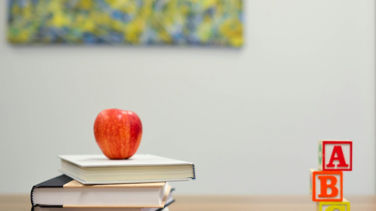 an apple sitting on top of school books