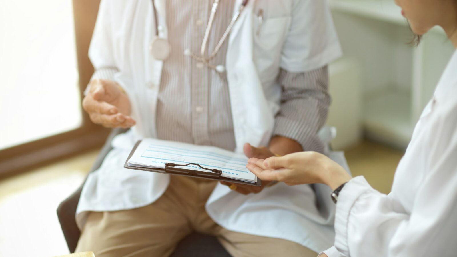 two medical professionals discussing a chart