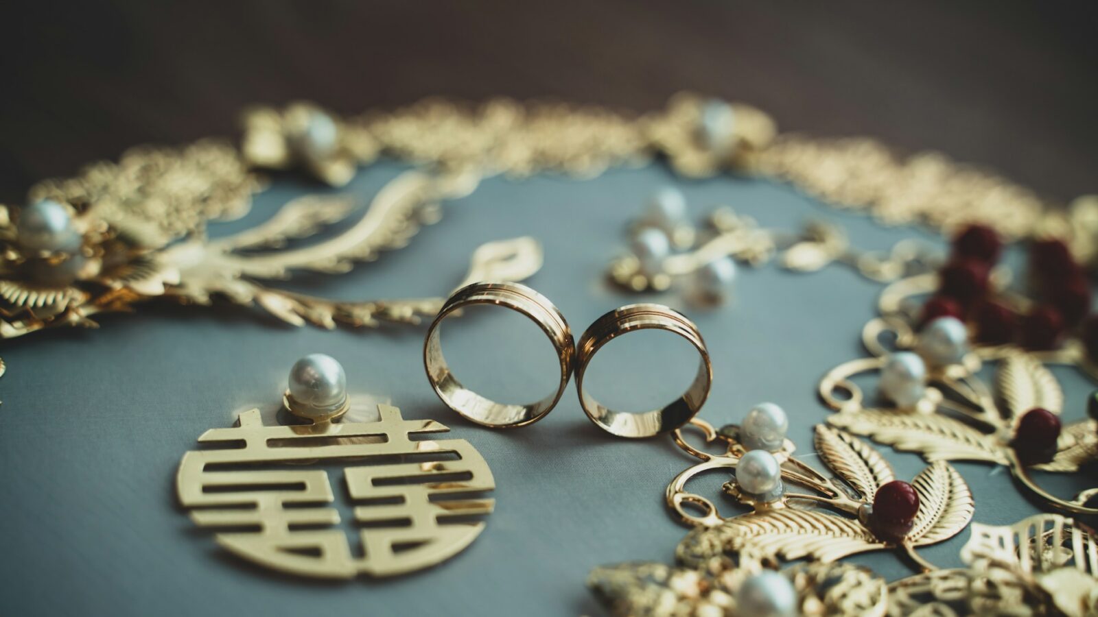 Chinese wedding rings surrounded by traditional jewellery, representing foreign marriages and family law claims in Ontario family courts.